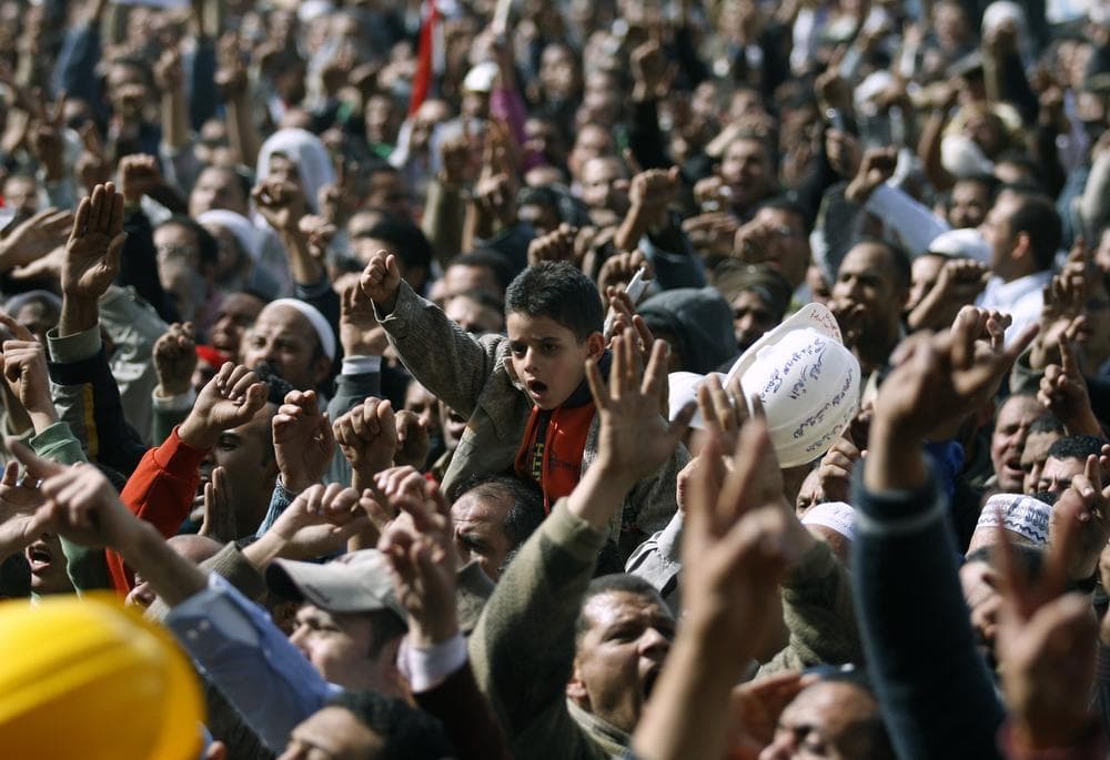 Anti-government protestors react in Tahrir Square, Cairo, Egypt, Friday, Feb. 4, 2011. (AP Photo/Khalil Hamra)