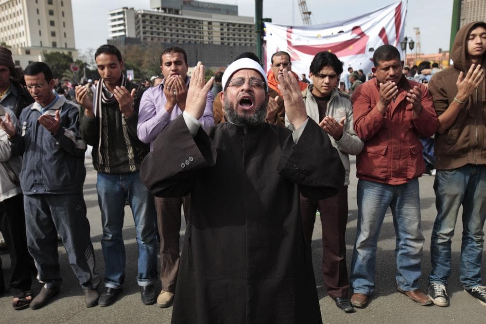 A Muslim cleric leads prayers of Egyptian anti-government demonstrators gathered in Tahrir Square, the center of anti-government demonstrations, in Cairo, Egypt, Sunday, Feb. 6, 2011. A sense of normalcy began to return to the capital of some 18 million people, which has been largely closed since chaos erupted shortly after the protests began on Jan. 25. (AP Photo/Lefteris Pitarakis)