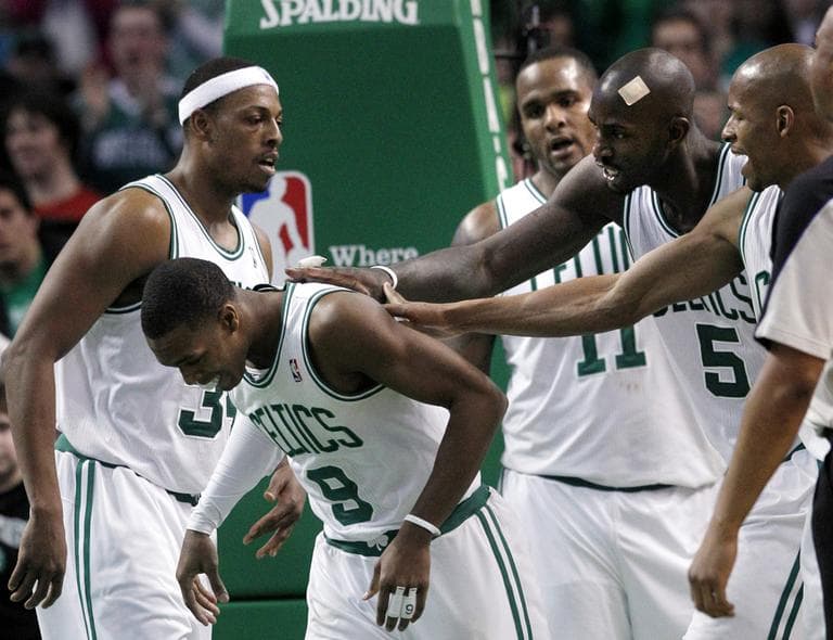 Boston Celtics point guard Rajon Rondo (9) is congratulated by teammates during the game against the Orlando Magic during an NBA basketball game in Boston on Sunday. (AP)