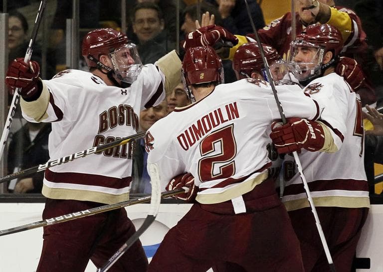 Boston College players mob Tommy Cross, right, after he scored in overtime, giving Boston College a 3-2 win over Boston University in a Beanpot college hockey tournament game in Boston on Monday, Feb. 7, 2011. (AP Photo/Winslow Townson)