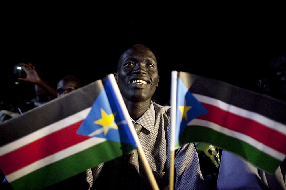 A southern Sudanese man watches a publicly televised broadcast of the formal announcement of referendum results in the southern capital of Juba. (AP)