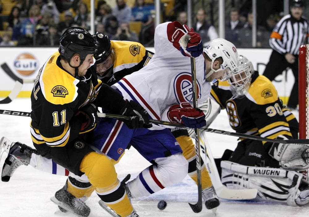 Boston Bruins center Gregory Campbell (11) and defenseman Johnny Boychuk, center rear, defend against Montreal Canadiens left wing Tom Pyatt while Boston goalie Tim Thomas (30) protects the net during the game in Boston on Wednesday. (AP)