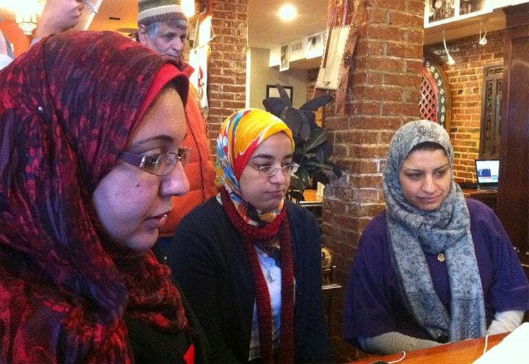 From left, graduate students Dina El-Zanfaly, Amira Hussein and Lamia Youseff watch the events in Egypt from Cambridge Thursday. (Bianca Vazquez Toness/WBUR)