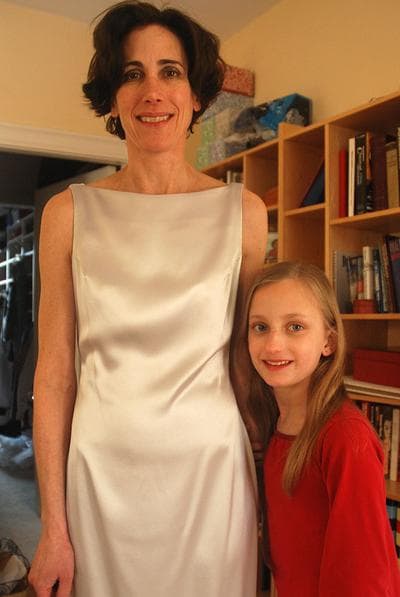 Harpist Sarah Schuster Ericsson, with her daughter, shows off the gown she'll wear to the Grammys Sunday. (Andrea Shea/WBUR)