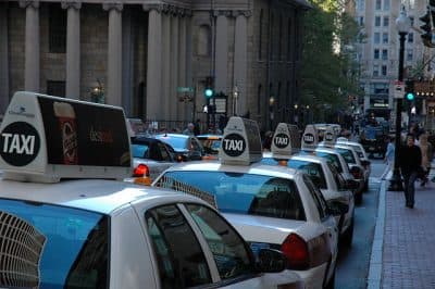 Cabs wait at a taxi stand near Tremont Street in Boston. (rkelland/Flickr)