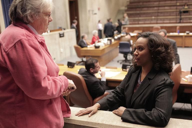 Boston City Councilor Ayanna Pressley, right, talks with Anne Schmalz, an observer from the League of Women Voters, at a recent council meeting. (Nick Dynan for WBUR)