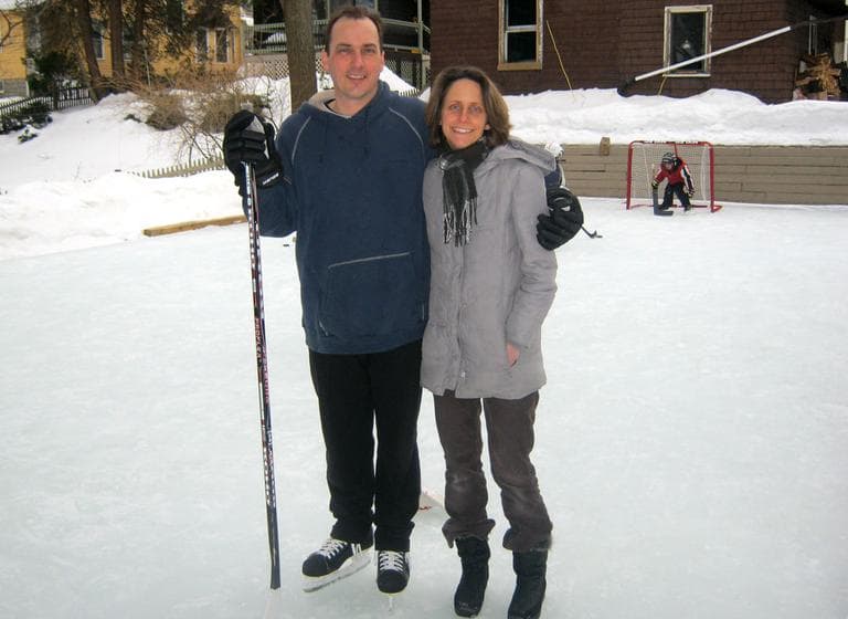 Robert and Emily Norton stand proudly on their backyard ice rink in Newton. (Courtesy of Dom Leal)