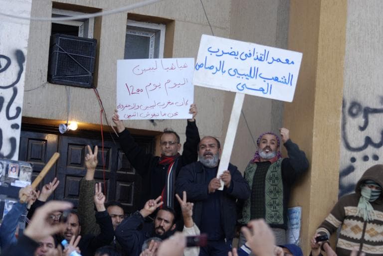 This photograph, obtained by The Associated Press outside Libya and taken by an individual not employed by AP, shows people shouting and holding signs during recent days' unrest in Benghazi, Libya. (AP)