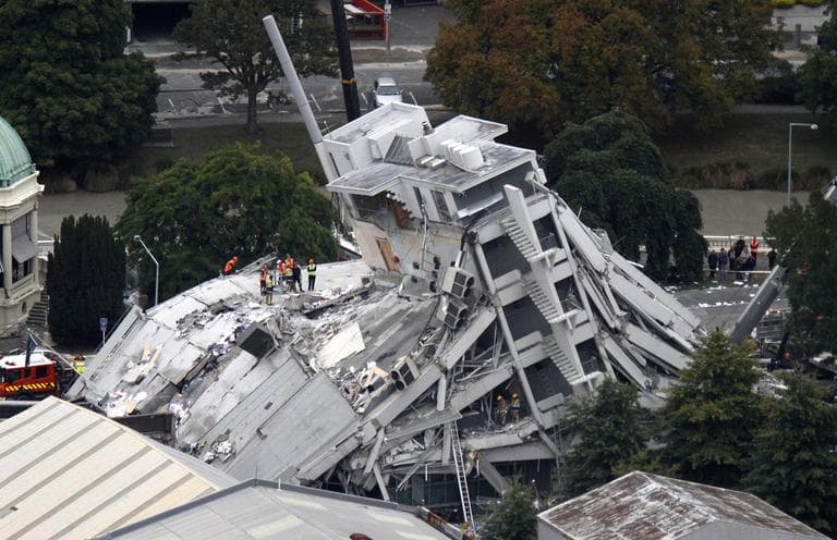 Rescue workers climb onto the collapsed Pyne Gould Guinness Building in central Christchurch, New Zealand, Tuesday. (AP)