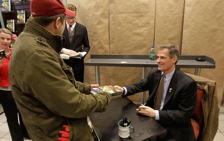 Sen. Scott Brown hands his new book, &quot;Against All Odds,&quot; back to a customer after signing the copy at Barnes &amp;amp; Noble in Boston on Tuesday. (AP)