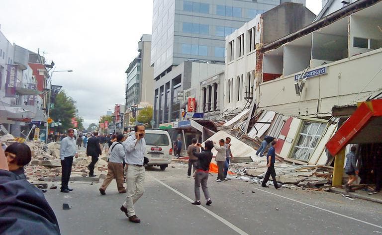 People walk through a street partly covered with rubble after an earthquake hit Christchurch, New Zealand, Tuesday, Feb. 22 (AP)