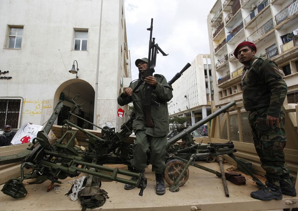 Gunmen prepared to fight against Libyan leader Moammar Gadhafi stand on a small military truck with weapons taken from a Libyan military base, in Benghazi, Libya, on Thursday Feb. 24, 2011. (AP)