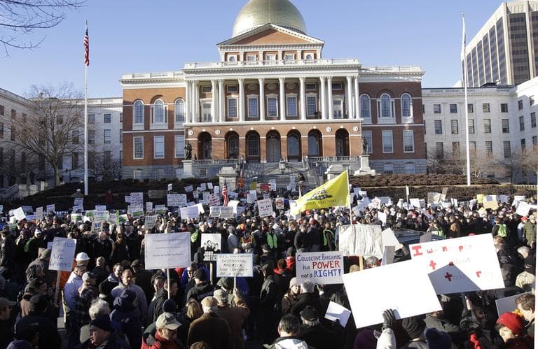 Union supporters and detractors rally in response to protests in Wisconsin outside the Statehouse in Boston, Tuesday. (AP Photo/Stephan Savoia)