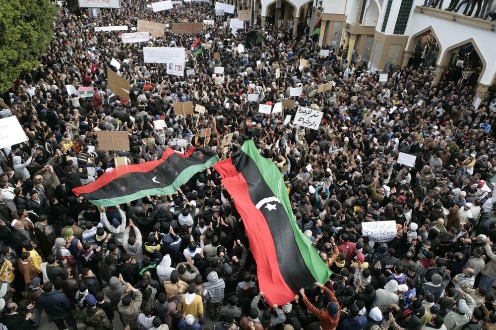 In this photo released by China's Xinhua News Agency, Libyan protesters demonstrate against Libyan leader Moammar Gadhafi during a rally at the Court Square in Derna, northeastern Libya, on Friday, Feb. 25, 2011. (AP)