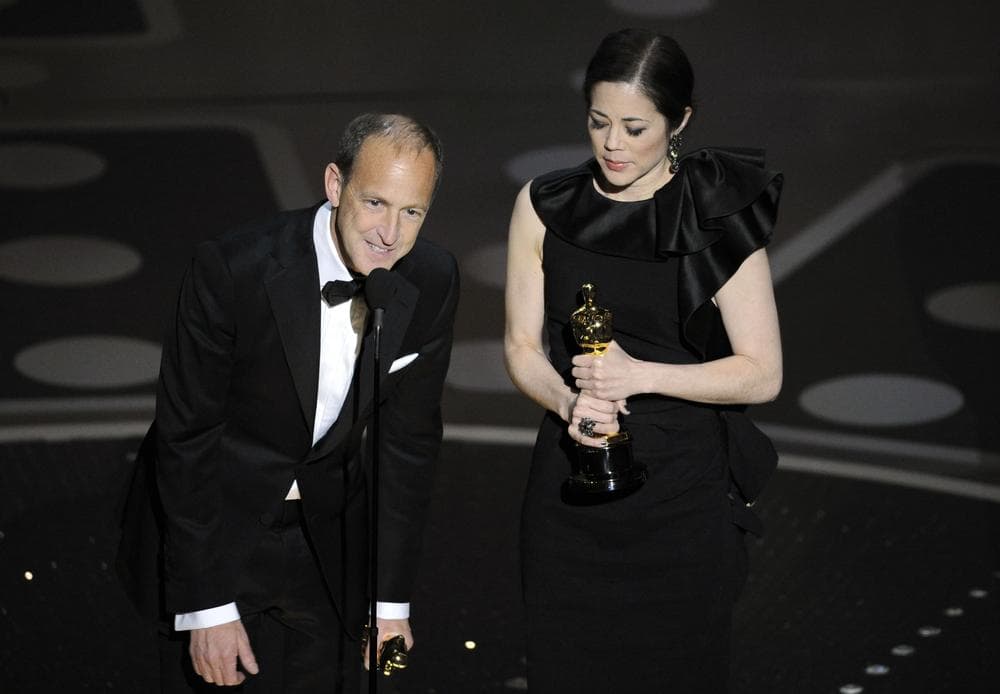 Producers Charles Ferguson, left, and Audrey Marrs accept the award for best documentary feature for &quot;Inside Job&quot; during the 83rd Academy Awards in Los Angeles. (AP)