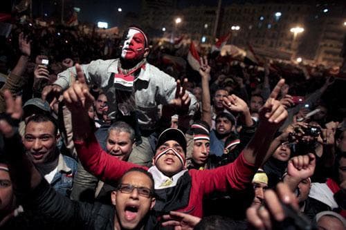 Egyptians celebrate the news of the resignation of President Hosni Mubarak, who handed control of the country to the military, at night in Tahrir Square in downtown Cairo, Egypt Friday, Feb. 11, 2011. (AP)