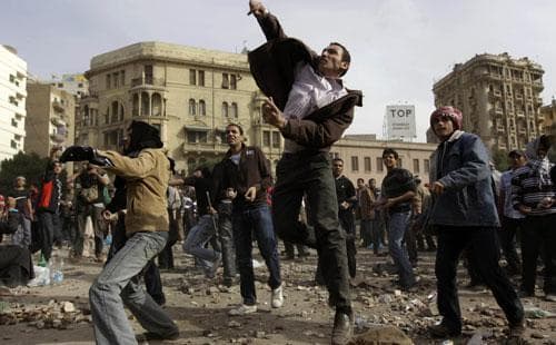 Anti-government protestors throw stones during clashes in Cairo, Egypt, Feb. 3, 2011. (AP)