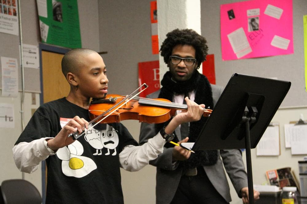 Roy&#039;al Sanyika-Hall, 13, auditions at the Boston Arts Academy with strings instructor Bryan Brash.  (Kirk Carapezza for WBUR)