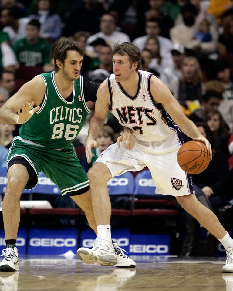 In this file photo taken Dec. 5, 2010, New Jersey Nets' Troy Murphy (7) moves with the ball as former Celtics' Semih Erden defends. (AP)