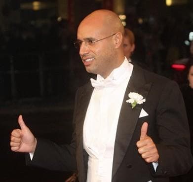 Saif al Gadhafi, son of Libyan leader Moammar Gadhafi, gives his thumbs up when arriving for the traditional opera ball in front of the state opera in Vienna, on Thursday, Feb. 11, 2010. (AP)