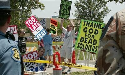 Supporters of the Rev. Fred Phelps, of the Topeka, Kan.-based Westboro Baptist Church, demonstrate outside the funeral service for Marine Lance Cpl. Rex Arthur Page, Sunday, July 9, 2006, in Kirksville, Mo. (AP)