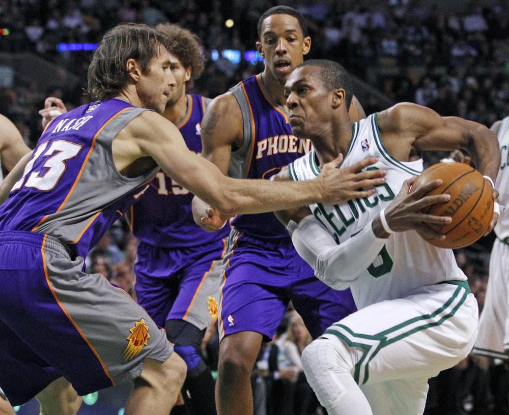 Boston Celtics point guard Rajon Rondo (9) makes a move against the defense of Phoenix Suns point guard Steve Nash (13) and center Channing Frye, middle, during the first quarter of the game in Boston on Wednesday. (AP)