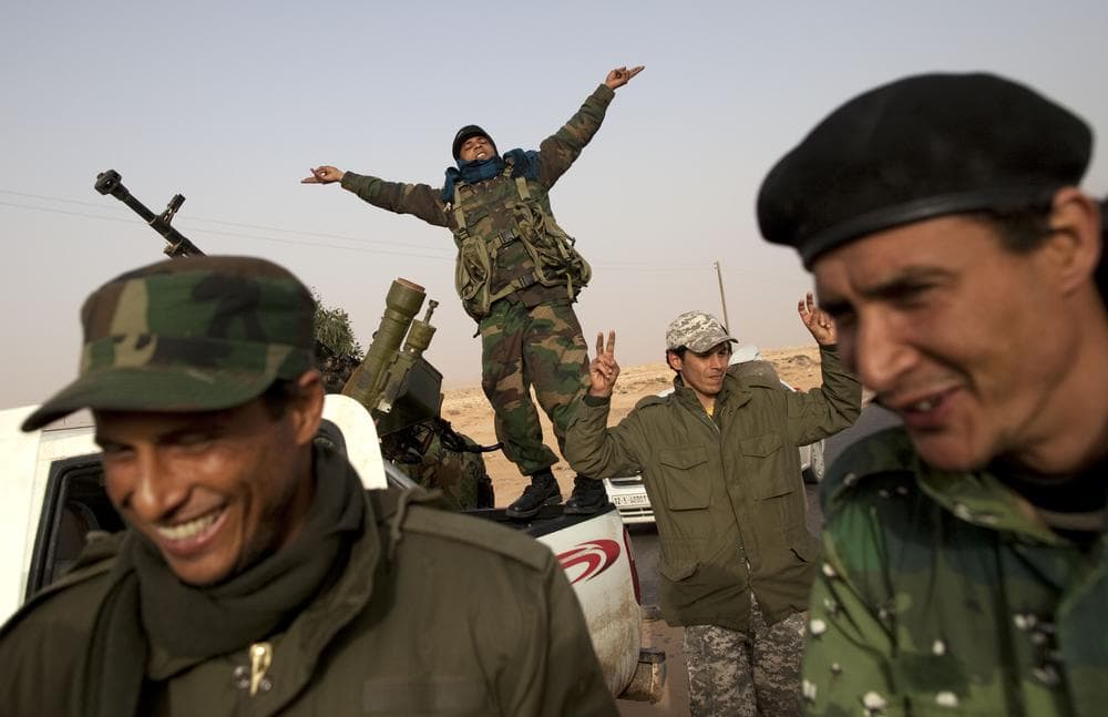 Libyan rebels who are part of the forces against leader Moammar Gadhafi celebrate their victory in fighting against troops loyal to Gadhafi in the oil town of Ras Lanuf, eastern Libya, on Saturday. (AP)