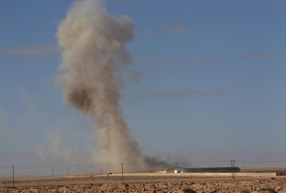 Smoke raises from a military army base which fell to the anti-Libyan Leader Moammar Gadhafi rebels following an air strike by Libyan warplanes that attacked in the oil town of Ras Lanouf, eastern Libya, on Sunday.  (AP)