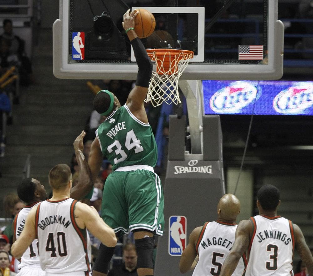 Boston Celtics&#39; Paul Pierce, center, goes up for a dunk against the Milwaukee Bucks in the second half of the game Sunday in Milwaukee. (AP)