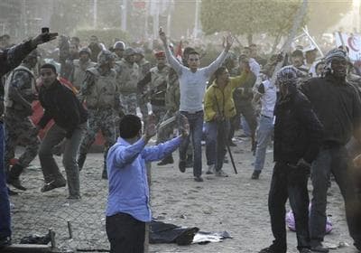 Egyptians who oppose the continued presence of protesters at Tahrir Square, the focal point of the Egyptian uprising in Cairo, and army soldiers prepare to remove the belongings of youths camping out at the square in order to press their demand for a complete break with the ousted regime. (AP)