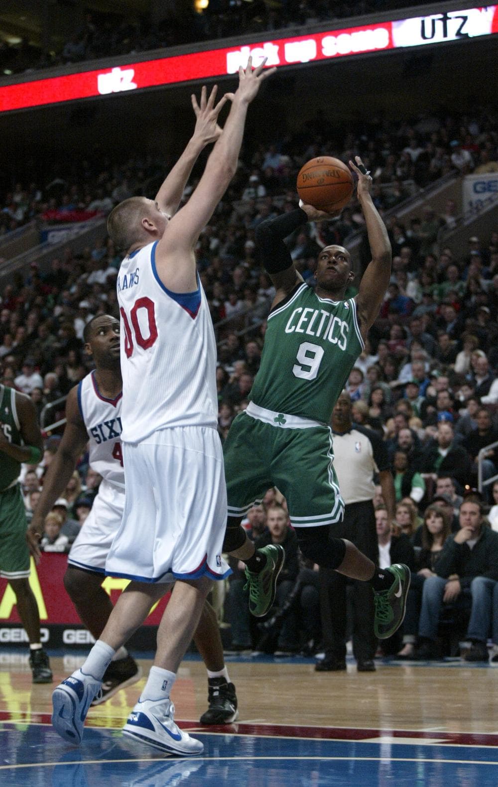 Celtics' Rajon Rondo shoots over Philadelphia 76ers' Spencer Hawes in the first half, Friday in Philadelphia. (AP)