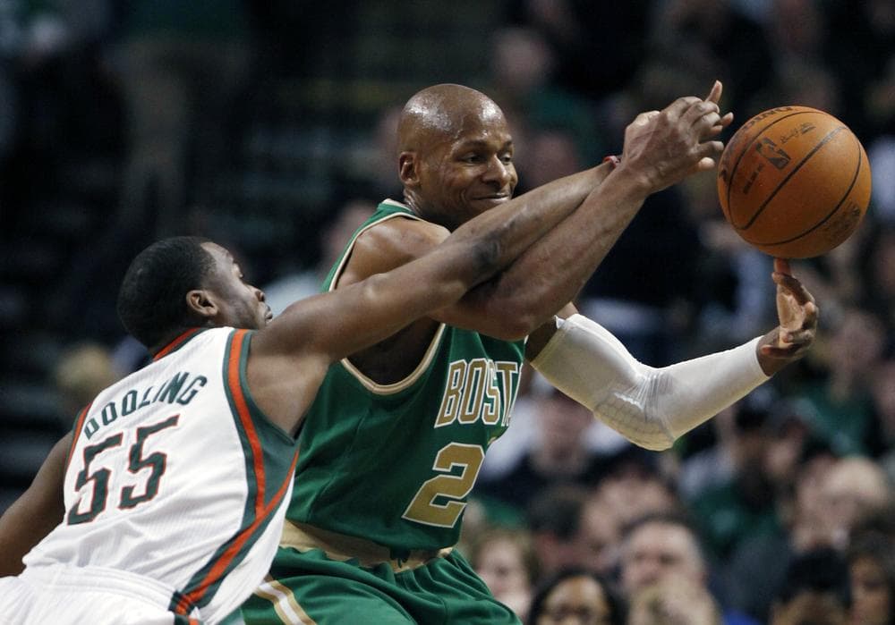 Boston Celtics' Ray Allen, right, and Milwaukee Bucks' Keyon Dooling (55) battle for a loose ball in the third quarter of the game on Sunday in Boston. The Celtics won 87-56. (AP)