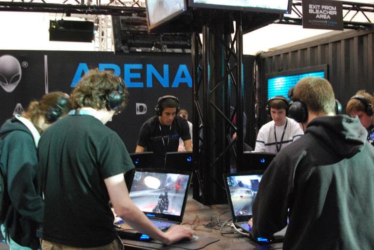 Gamers get their game on at a booth in the BCEC at PAX East 2011. (CasualCapture/Flickr)
