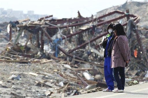 People look at a devastated area of Minamisanriku, northern Japan, Monday, three days after a powerful earthquake-triggered tsunami hit the country's east coast. (AP)