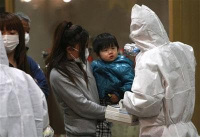 A child is screened for radiation exposure at a testing center in Koriyama city, Fukushima Prefecture, Japan. (AP)