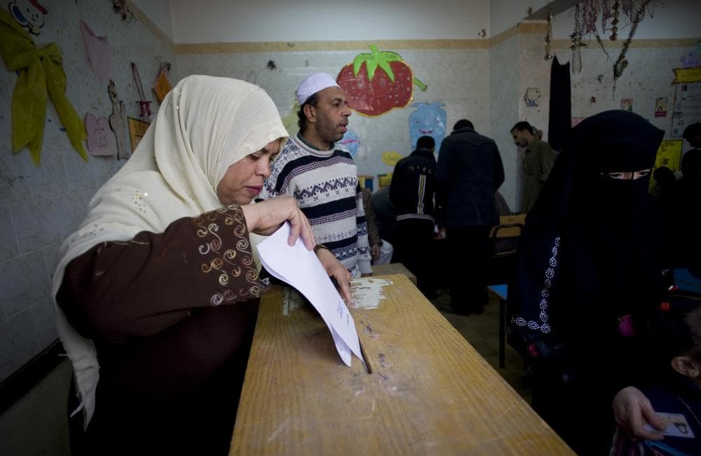 An Egyptian woman, left, casts her vote at a polling center in a referendum on constitutional amendments in Cairo&#39;s commercial district of Atabah, Egypt, Saturday, March 19, 2011. The nationwide referendum is the first major test of the country&#39;s transition to democracy after a popular uprising overthrew President Hosni Mubarak&#39;s authoritarian rule on Feb. 11. (AP)