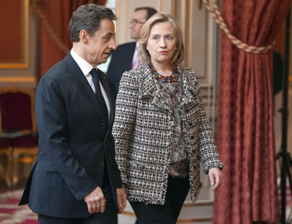 French President Nicolas Sarkozy accompanies U.S. Secretary of State Hillary Clinton on Saturday before a summit at the Elysee Palace in Paris, on implementing the U.N. Security Council resolution 1973 authorizing military action in Libya.  (AP/Pool)