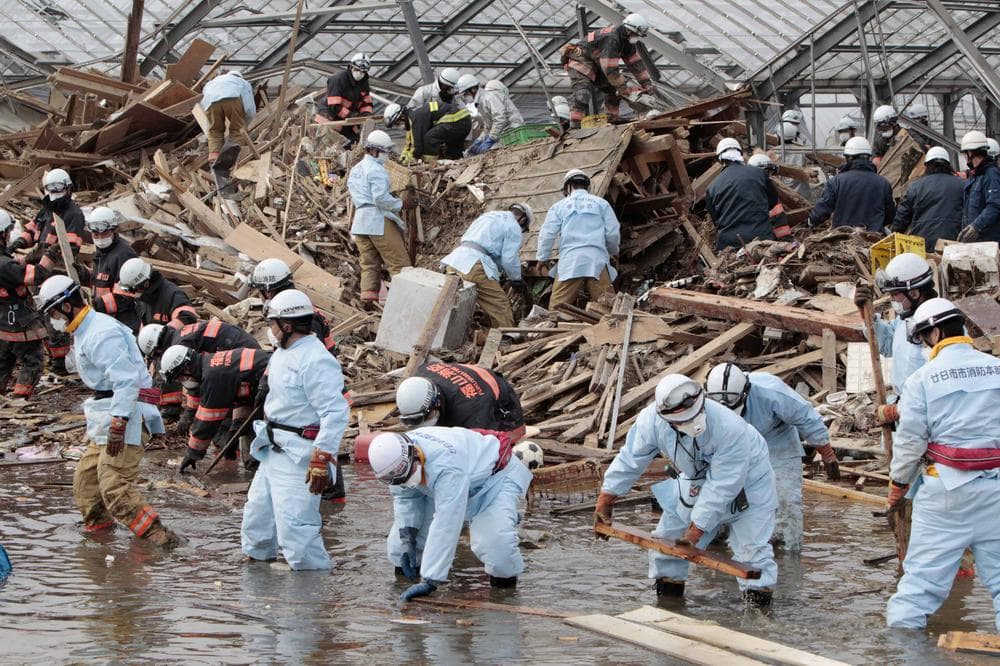 Rescue workers sift through the remains of a property in the suburb of Natori, Sendai, Miyagi Prefecture, Japan, Sunday, March 20, 2011 after the March 11 earthquake and tsunami devastated the area.  (AP)