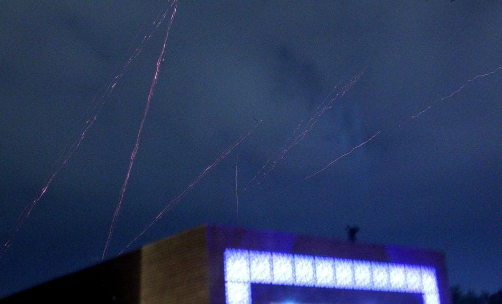 Tracer bullets are seen in the skies over Tripoli, Libya, as heavy explosions rock the city early Sunday.  (AP)