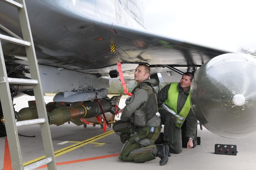 Soldiers fix a GBU.12 bomb on a French Mirage 2000 jet fighter at the military base of Nancy, eastern France. The Mirages 2000 are operating over Libya. (AP/SIRPA AIR) 