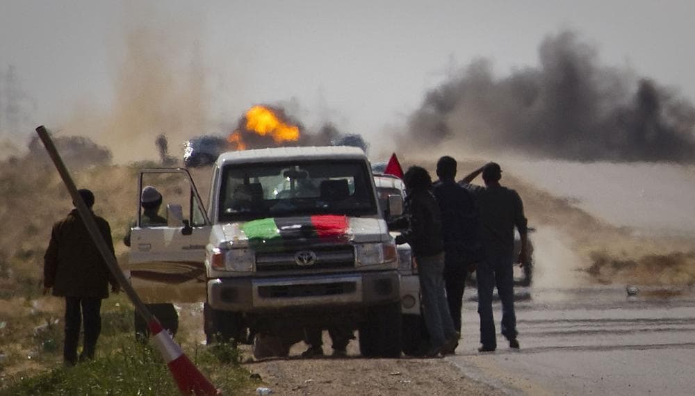 Libyan rebels stop on the road as mortars from Moammar Gadhafi's forces are fired on them on the outskirts of the city of Ajdabiya, south of Benghazi, eastern Libya Tuesday. (AP)