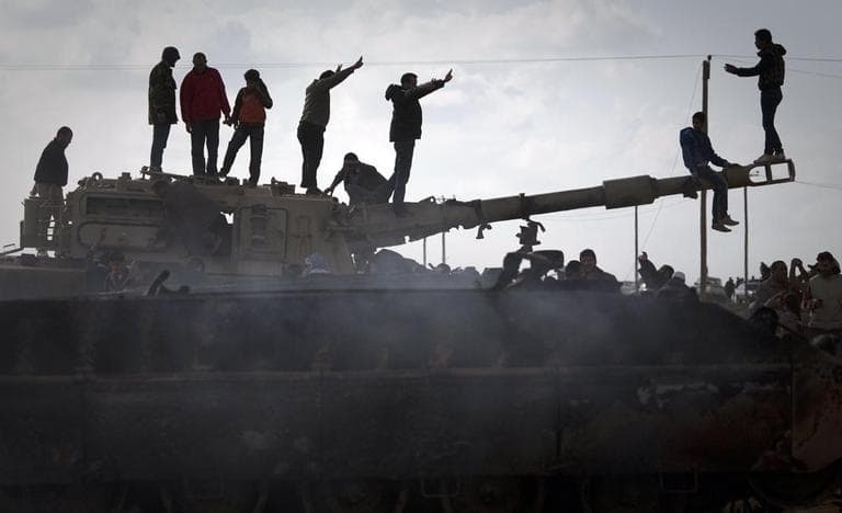 Libyan people celebrate on a tank belonging to the forces of Moammar Gadhafi in the outskirts of Benghazi, eastern Libya, Sunday. (AP /Anja Niedringhaus)