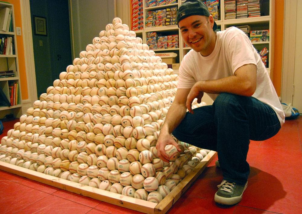 Zack Hample and a pyramid of the baseballs he collects. (Anchor)