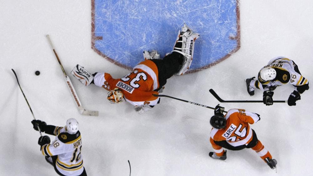 Philadelphia Flyers' Brian Boucher (33) throws his stick, trying to block a shot by Boston Bruins' Nathan Horton (18) as Matt Carle (25) and David Krejci (46), of Czech Republic, look on during the third period of the game on Sunday in Philadelphia. Boston won 2-1. (AP)