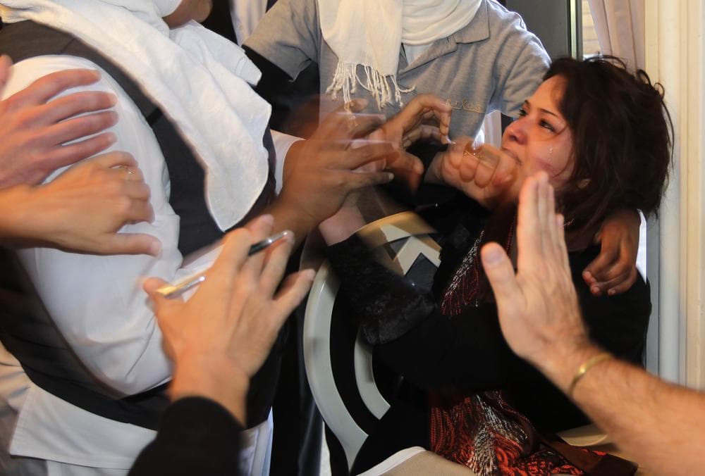 Hands from hotel employees trying to grab her, and foreign journalist attempting to protect her, surround Iman Al-Obeidi, right, who said she spent two days in detention after being arrested at a checkpoint in Tripoli, Libya, and was sexually assaulted by up to 15 men while in custody. (AP)