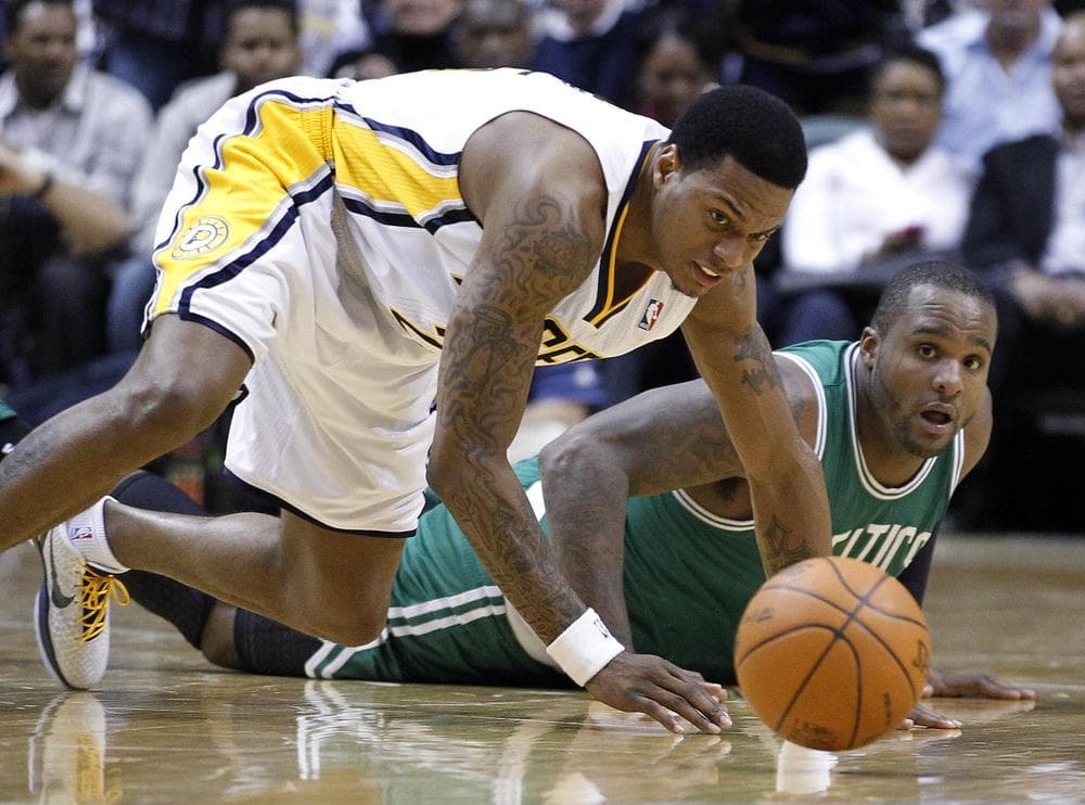Indiana Pacers guard Brandon Rush, left, and Boston Celtics forward Glen Davis go to the floor for a loose ball in the second half the game in Indianapolis on Monday. The Pacers defeated the Celtics 107-100. (AP)