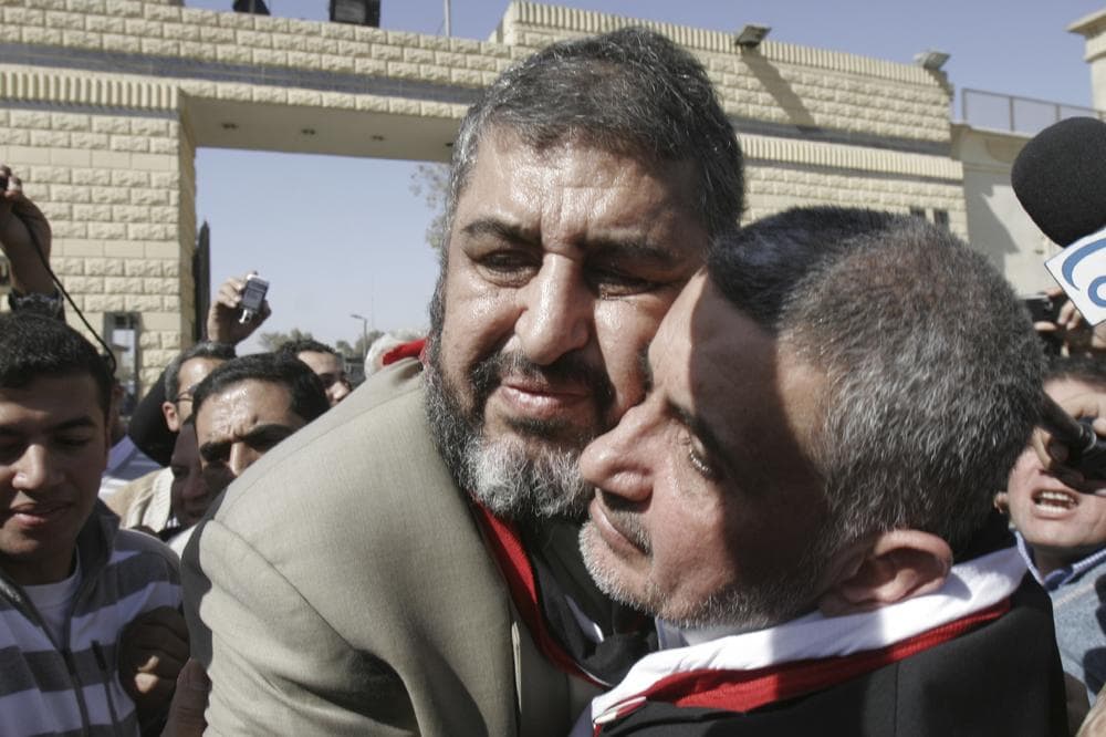 Khayrat el-Shater, the lead strategist for Egypt's largest opposition group, hugs Hassan Malek, a prominent businessman and group financier, right, in Cairo, Egypt after the two were released from prison. (AP)