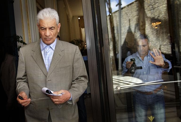 Libya's Foreign Minister Moussa Koussa leaves after reading a statement to journalists in Tripoli March 18. (AP)