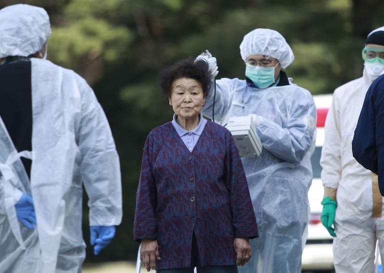 Residents evacuated from areas surrounding the Fukushima nuclear facilities damaged in Friday&#039;s massive earthquake, are checked for radiation contamination, Sunday, Japan. (AP/Wally Santana)