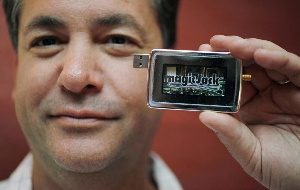 Dan Borislow holds up his invention, the magicJack, at the Consumer Electronics Show in January 2010. (AP)